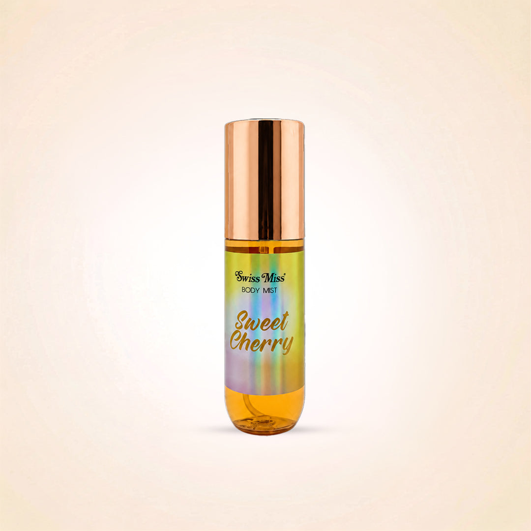 A roll-on body mist bottle with a metallic rose gold cap and a label that reads 'Swiss Mist BODY MIST' and 'Sweet Cherry' in gold script, set against a light beige background.