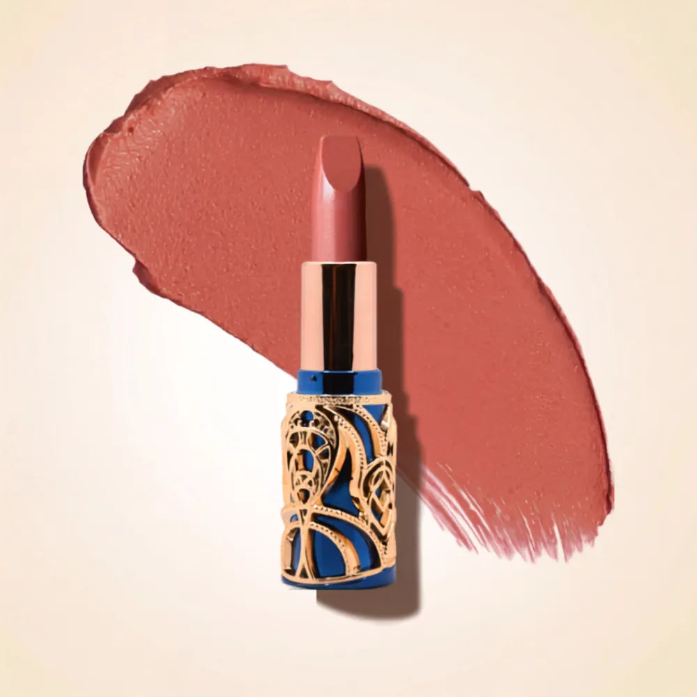 Swiss Miss Bling Lipstick in shade Deep Rose B-104 featuring ornate blue and gold filigree bullet tube casing with a warm medium rosy pink lipstick swatch.