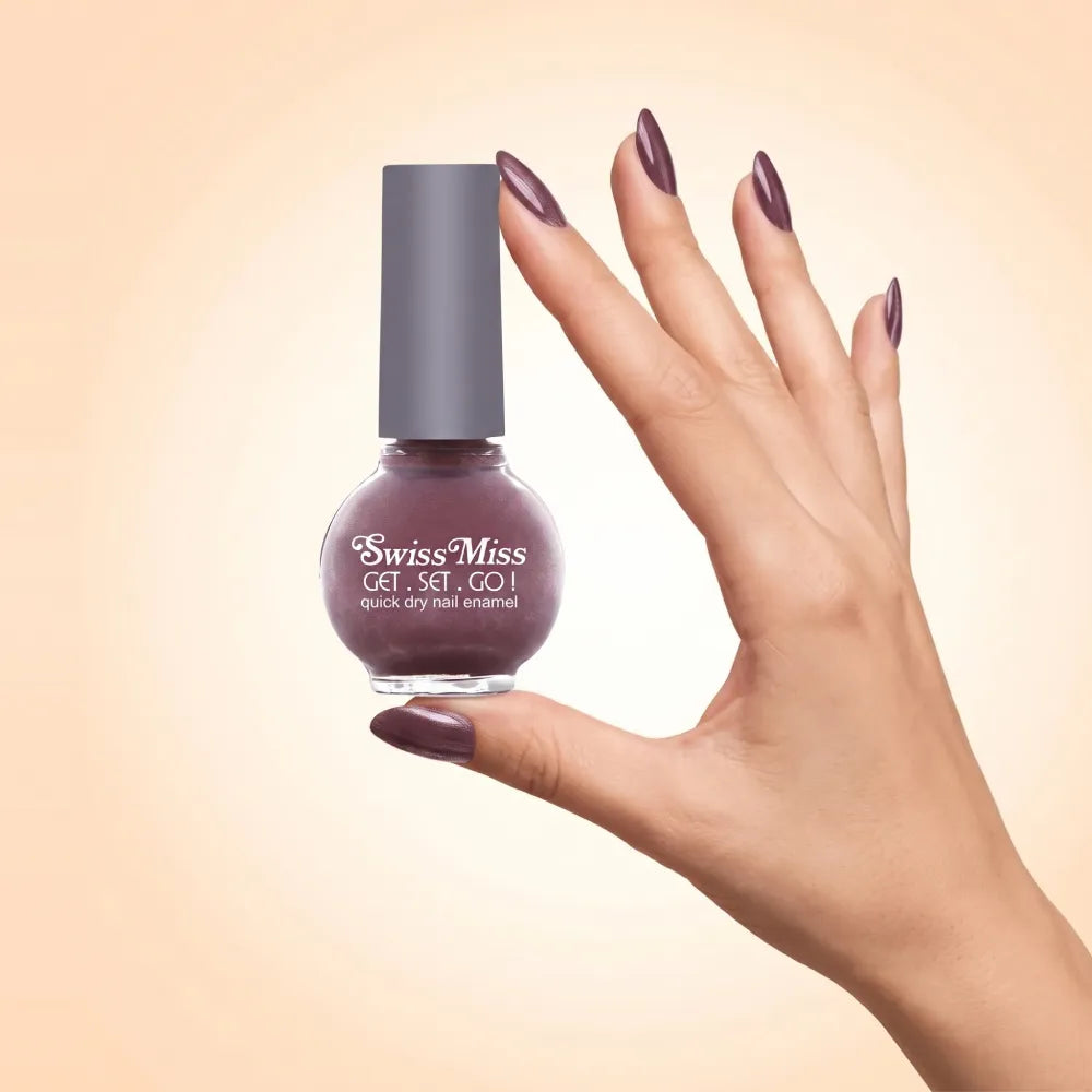 Swiss Miss Get Set Go Quick Dry Nail Enamel in shade Moonless Nite 234 held by hand showing round glass bottle with shimmering metallic smoky plum brown polish and matching manicured nails.