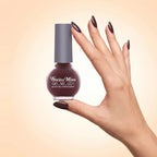 Swiss Miss Get Set Go Quick Dry Nail Enamel in shade Terracotta 208 held by hand showing round glass bottle with deep terracotta burgundy brown polish and matching manicured nails.
