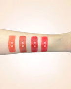 Arm swatches comparing Swiss Miss lipstick shades B113, B114, B115, and B116.