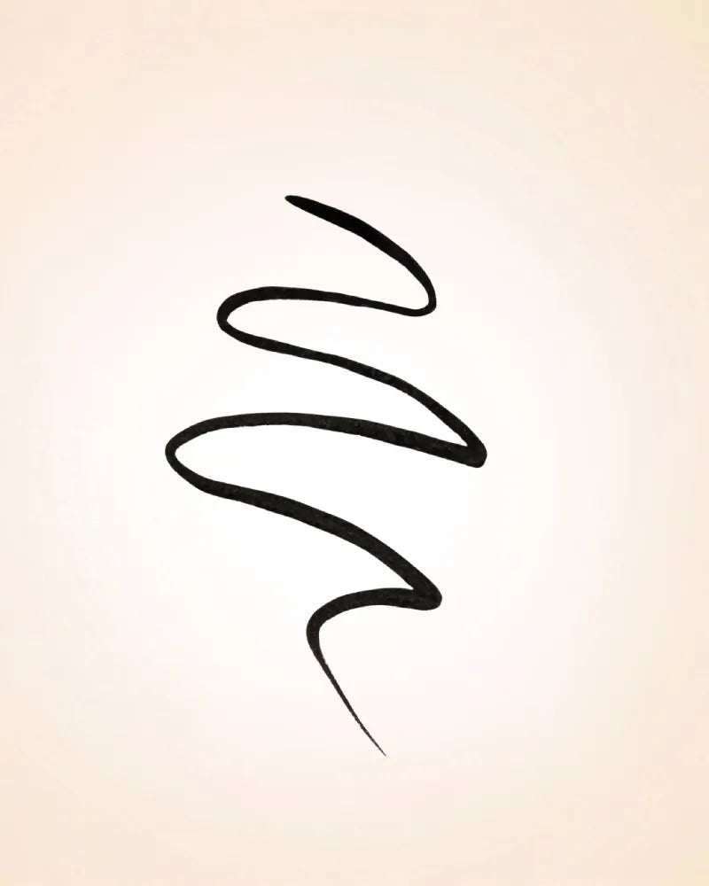 Pigmented black liquid eyeliner swatch drawn in a wave pattern demonstrating line precision and intensity of Swiss Miss Eyeliner.