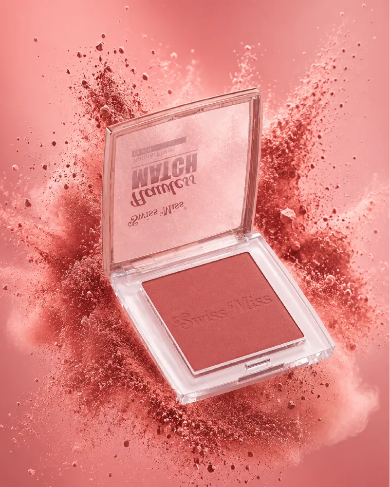 Swiss Miss Flawless Match single powder blush compact in shade Natural Peach SM 001 surrounded by a peach-pink powder burst.
