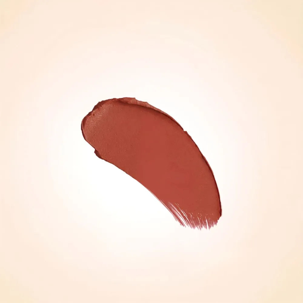 Rich terracotta bronze-brown texture swatch of Swiss Miss Bronze Affair B-113 lipstick on a neutral background.