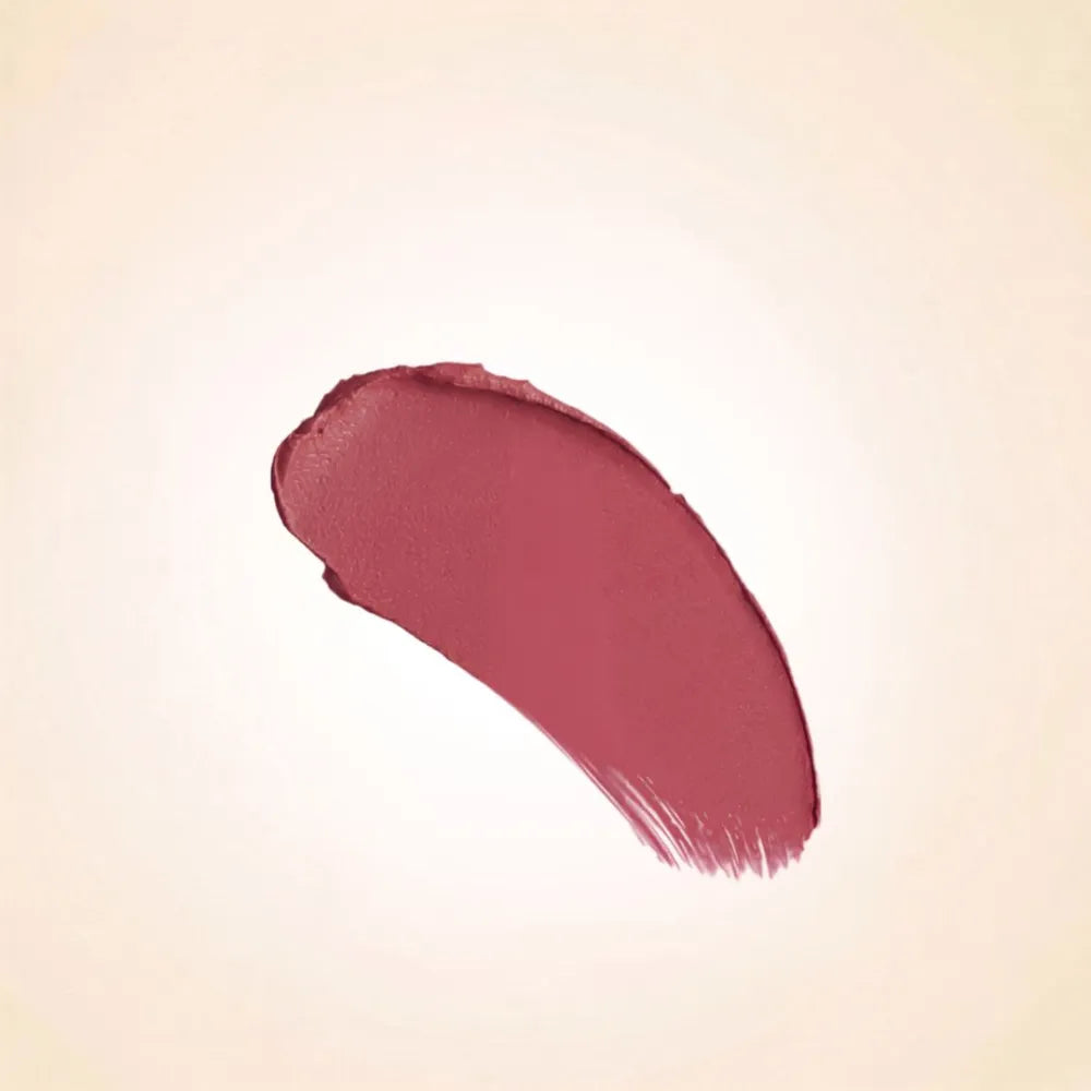 Soft rosy mauve-cocoa texture swatch of Swiss Miss Cashmere Cocoa B-105 lipstick on a neutral background.