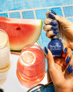 Hand holding Swiss Miss Cobalt Craze F-407 Get Set Go quick dry nail enamel bottle displaying rich vibrant cobalt blue polish applied on long nails.