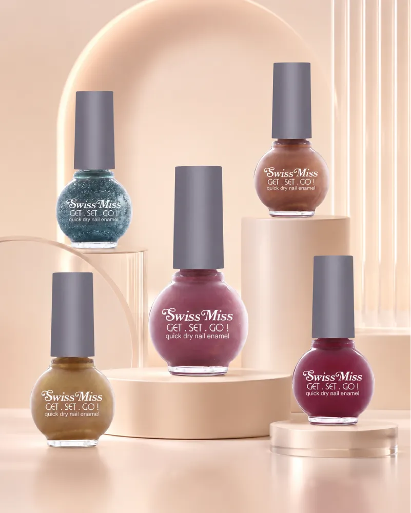 Collection of Swiss Miss Get Set Go quick dry nail enamel bottles displayed on aesthetic podiums.