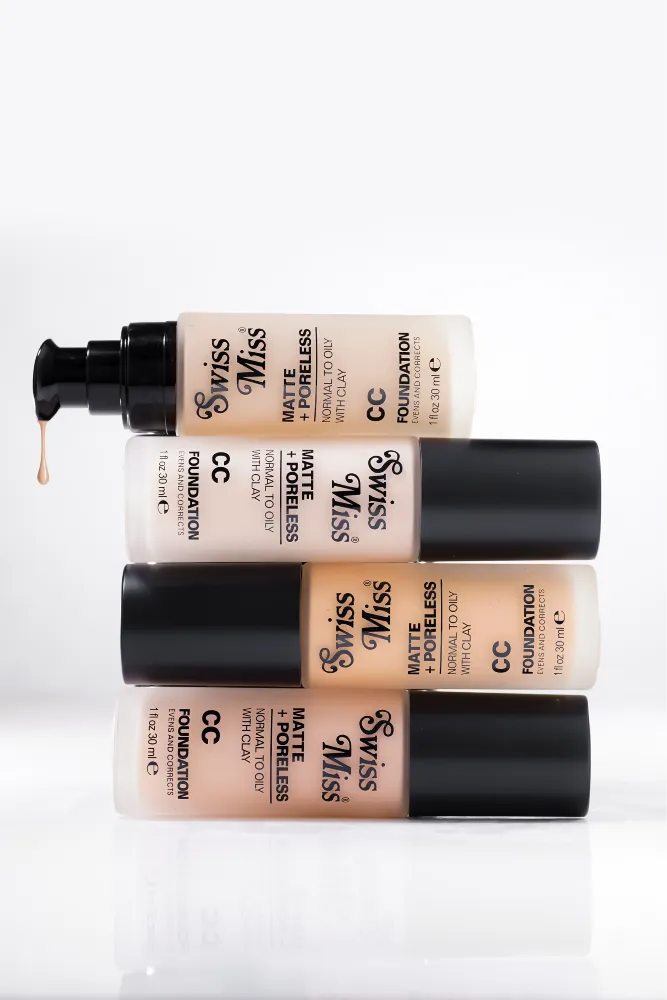 Stacked bottles of Swiss Miss Matte and Poreless CC Foundation showing the full shade collection with a pump drop