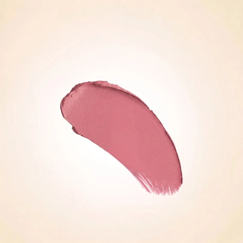 Soft rosy mauve texture swatch of Swiss Miss Mocha Mousse B-102 lipstick on a neutral background.