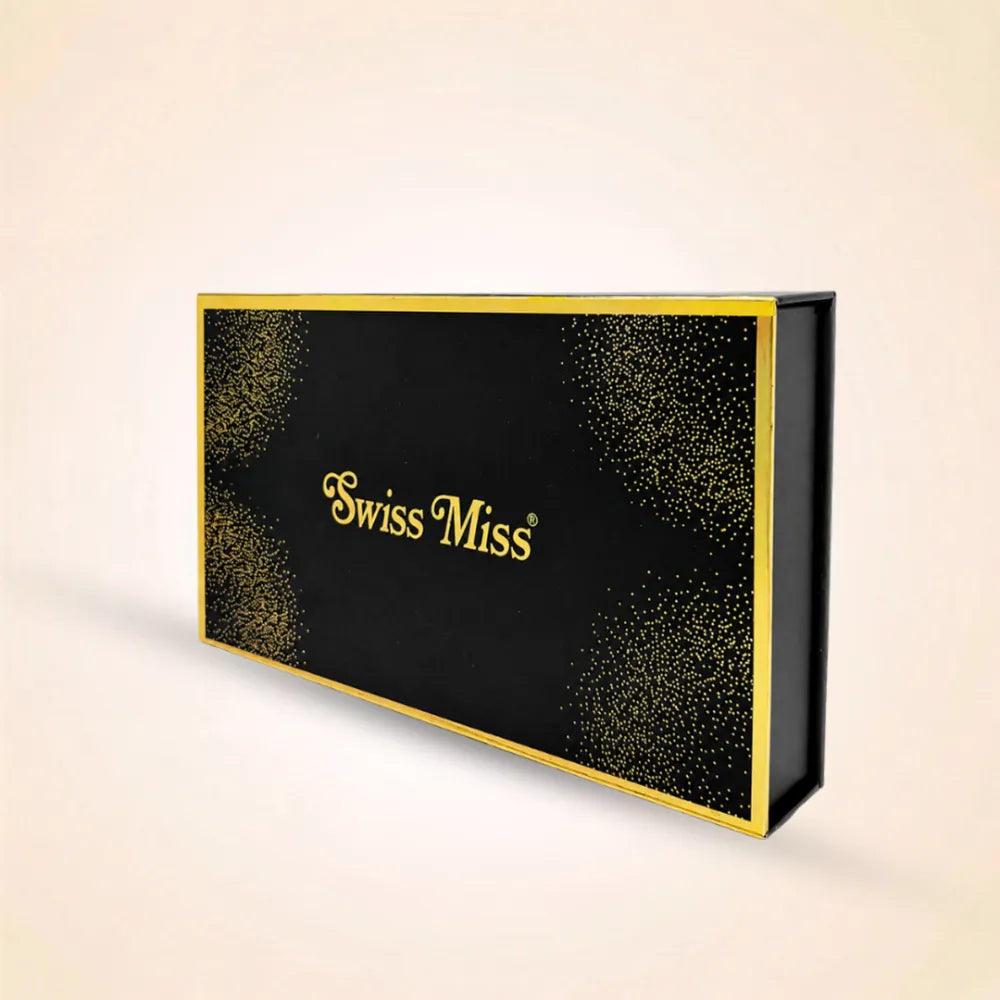 Closed black Swiss Miss perfume gift box featuring gold foil branding and elegant corner glitter accents.
