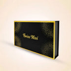 Closed black Swiss Miss perfume gift box featuring gold foil branding and elegant corner glitter accents.
