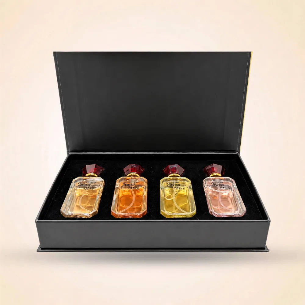 Front view of open black Swiss Miss perfume gift box showcasing a set of four mini fragrance bottles.