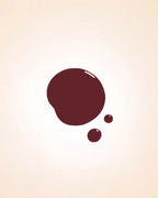 Glossy dark cherry red liquid nail polish drop swatch in shade Ribbon Red 224 showing finish and texture.