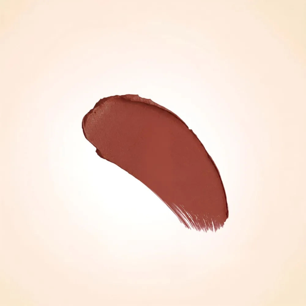 Deep warm chocolate brown texture swatch of Swiss Miss Show Stopper B-114 lipstick on a neutral background.
