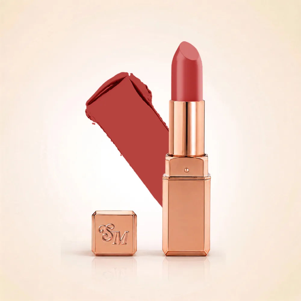 Swiss Miss Silk Lipstick in shade Base Pink (713) in gold bullet packaging shown alongside a textured cream color swatch.