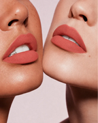 Close-up shot of two models with different skin tones wearing Swiss Miss Silk Lipstick in shade Clay Crush (704).