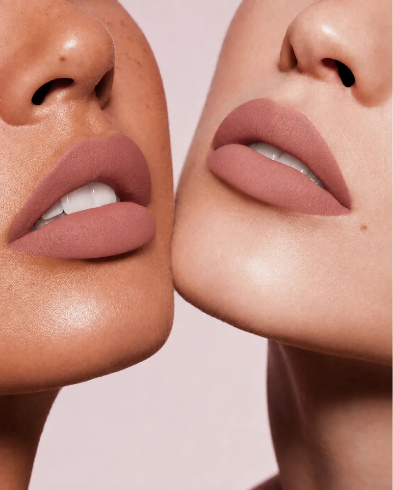 Close-up shot of two models with different skin tones wearing Swiss Miss Silk Lipstick in shade Desert Taupe (711).