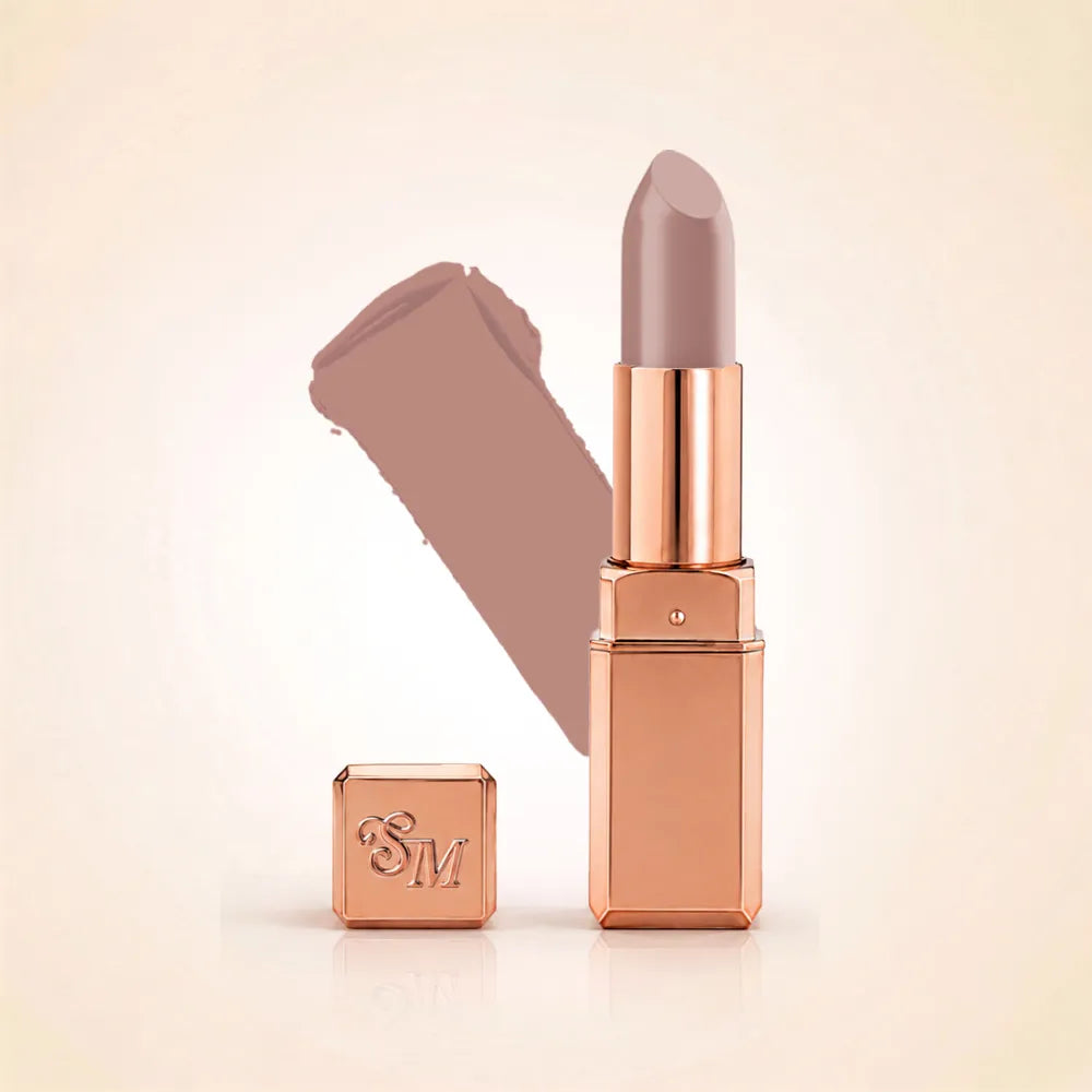 Swiss Miss Silk Lipstick in shade Desert Taupe (711) in gold bullet packaging shown alongside a textured cream color swatch.