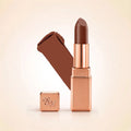 Swiss Miss Silk Lipstick in shade Espresso (730) in gold bullet packaging shown alongside a textured cream color swatch.