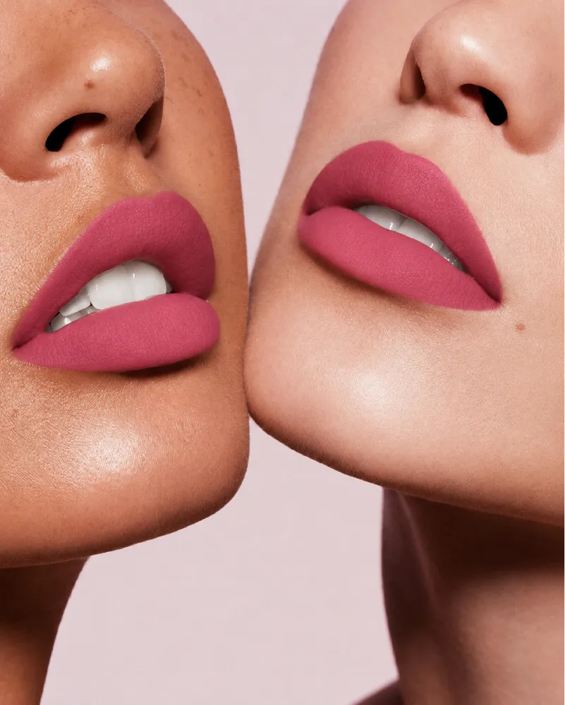 Close-up shot of two models with different skin tones wearing Swiss Miss Silk Lipstick in shade Fuchsia (719).