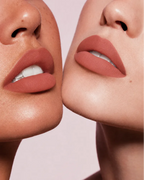 Close-up shot of two models with different skin tones wearing Swiss Miss Silk Lipstick in shade Glitter Bomb (729).