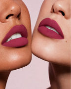 Close-up shot of two models with different skin tones wearing Swiss Miss Silk Lipstick in shade Mulberry (721).