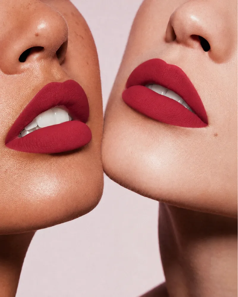 Close-up shot of two models with different skin tones wearing Swiss Miss Silk Lipstick in shade Ruby Pink (717).