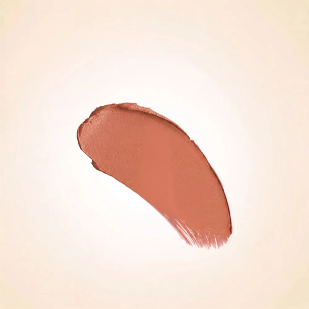 Creamy texture swatch of Swiss Miss Soft Brown B-101 lipstick on a neutral background.