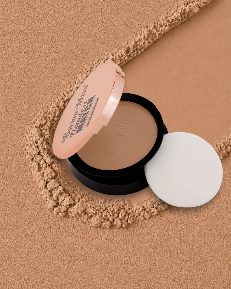 Swiss Miss Flawless Match Compact Powder open case with sponge applicator in shade Almond SM 04 over a warm tan textured powder background.