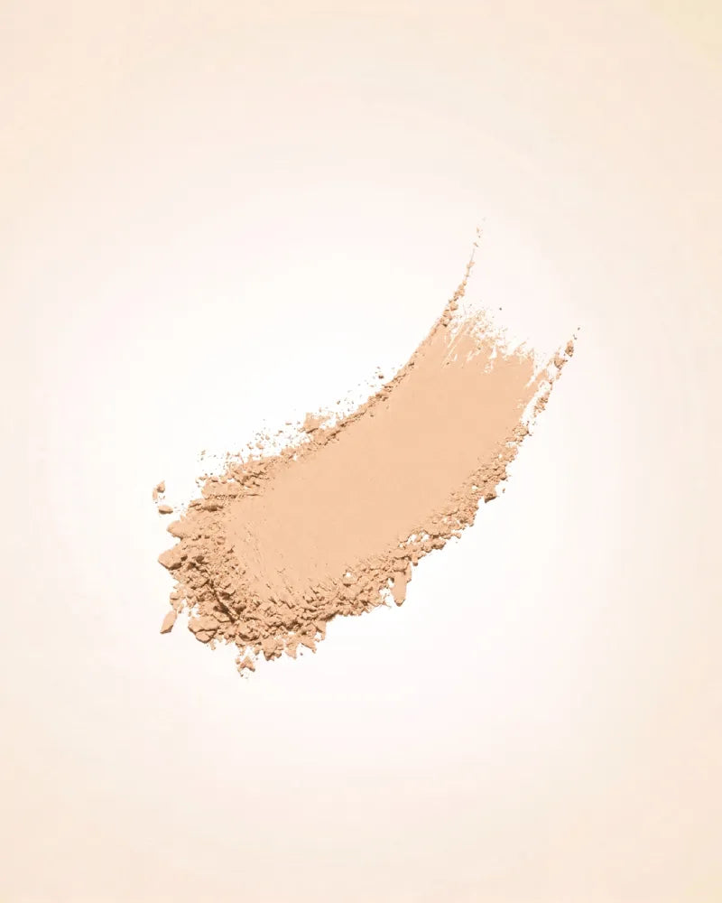 Smudged powder streak swatch demonstrating the fine texture and warm beige shade coverage of Swiss Miss Compact Powder in Natural Beige SM 03.